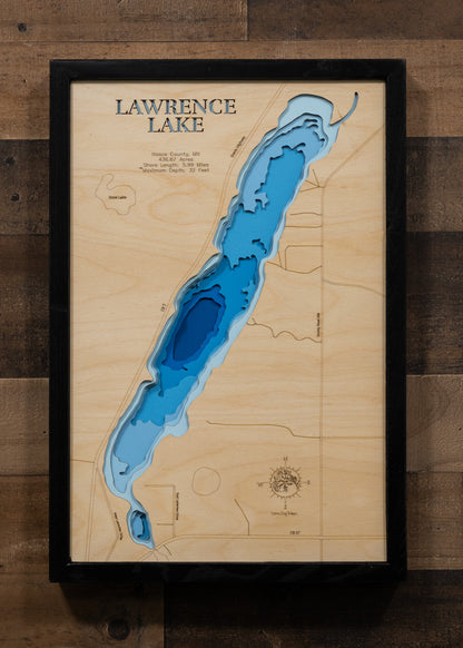 A laser-cut, layered wooden map of Lawrence Lake in Itasca County, Minnesota. The distinct shape of this natural lake, with its 5.99-mile shoreline, is clearly visible within the forested landscape of northern Minnesota. The varying depths of the lake, reaching a maximum of 32 feet, are represented by different layers of wood, illustrating its impressive underwater topography.