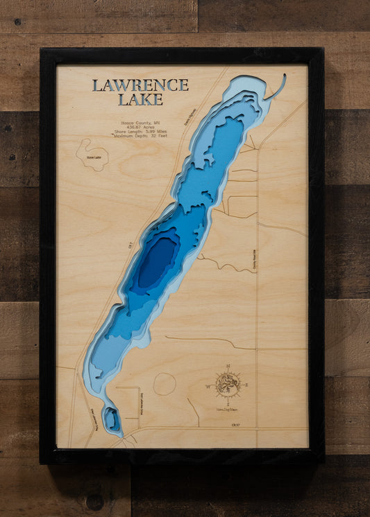 A laser-cut, layered wooden map of Lawrence Lake in Itasca County, Minnesota. The distinct shape of this natural lake, with its 5.99-mile shoreline, is clearly visible within the forested landscape of northern Minnesota. The varying depths of the lake, reaching a maximum of 32 feet, are represented by different layers of wood, illustrating its impressive underwater topography.
