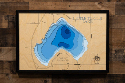 A precision laser-cut, multi-layered wooden map of Little Turtle Lake in Itasca County, Minnesota, a 492-acre Northwoods lake near Talmoon in the Big Fork River watershed with a diverse fishery including Tullibee, Walleye, and Bass. The natural wood top layer captures 4 miles of forested shoreline in fine detail, while a light-to-dark blue gradient conveys the lake's 29-foot depth. A handcrafted statement piece for any Minnesota lake cabin, home, or outdoor enthusiast's wall.