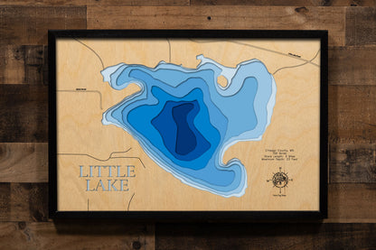 A precision laser-cut, multi-layered wooden map of Little Lake in Chisago County, Minnesota, near Center City in the heart of the Chisago Lakes region. The natural wood top layer captures 3 miles of intimate shoreline in fine detail, while a light-to-dark blue gradient conveys the lake's shallow, warmwater character. A handcrafted statement piece for any Minnesota lake home, cabin, or outdoor enthusiast's wall.