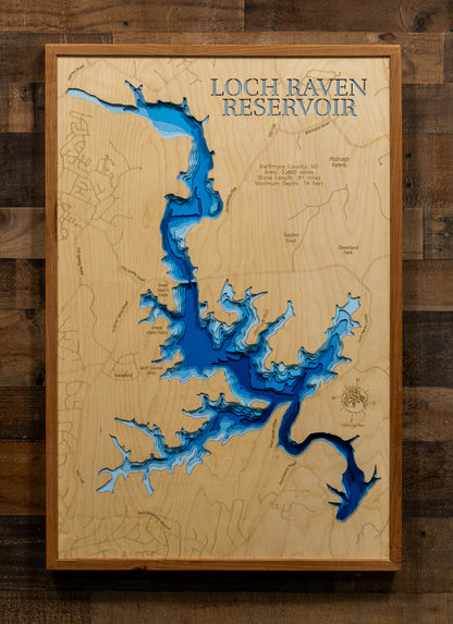 A laser-cut, layered wood map of Loch Raven Reservoir, Baltimore County, Maryland, showing its intricate shoreline winding through forested terrain.