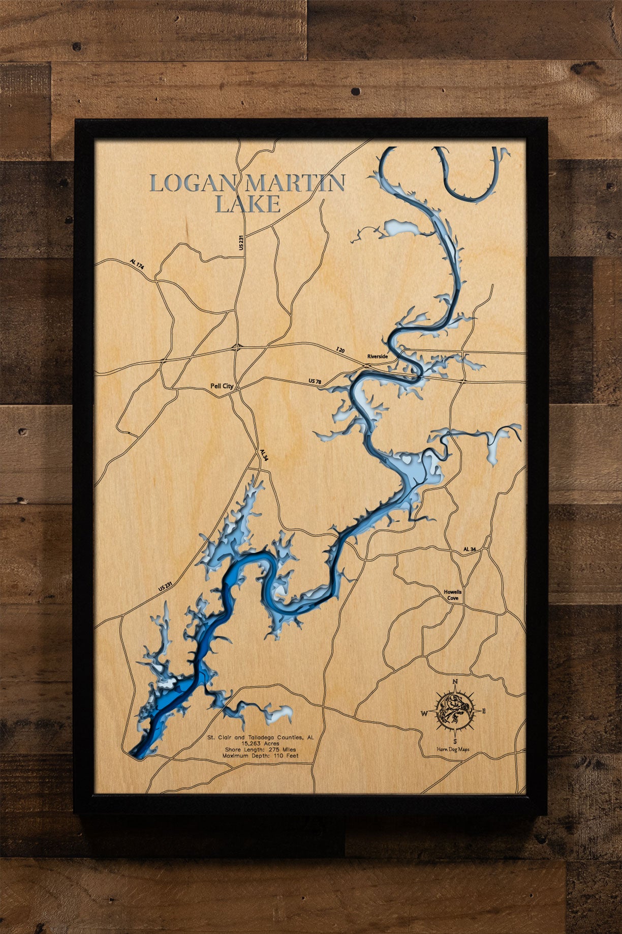 A precision laser-cut, multi-layered wooden map of Logan Martin Lake in St. Clair and Talladega Counties, Alabama — a 15,263-acre Coosa River reservoir nicknamed the "Lake of a Thousand Coves" with 275 miles of shoreline. The natural wood top layer captures every dramatic cove in fine detail, while a light-to-dark blue gradient conveys the lake's 110-foot depth. A handcrafted statement piece for any Alabama lake home, cabin, or outdoor enthusiast's wall.