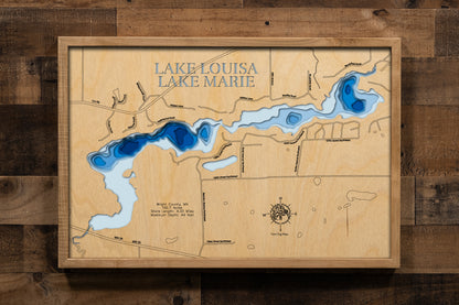 A beautifully crafted laser-cut wooden lake map of Lake Louisa in Wright County, Minnesota. The map features the lake's distinct shape and its connection to the surrounding landscape, with the water sections finished in a rich blue stain. Key statistics, such as the surface area and 44-foot maximum depth, are precisely etched into the wood, creating a unique and detailed piece of art that honors the geography of this beloved Wright County lake.