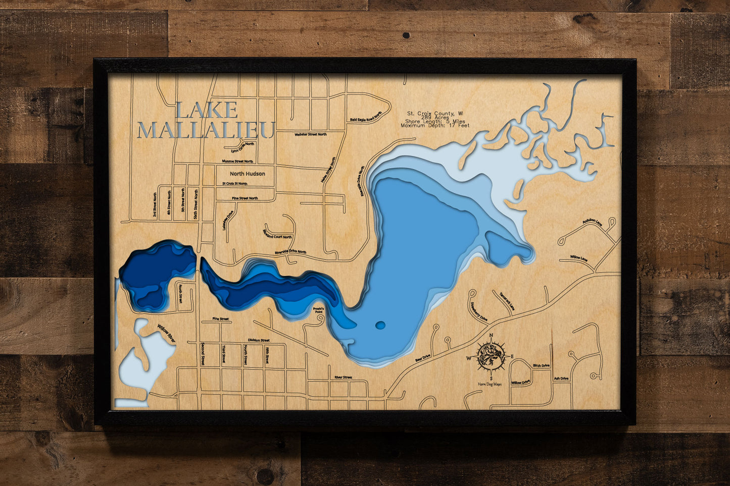 A precision laser-cut, multi-layered wooden map of Lake Mallalieu in St. Croix County, Wisconsin, a 289-acre Willow River flowage in North Hudson connected to the St. Croix River near the Minnesota border. The natural wood top layer captures 5 miles of natural shoreline in fine detail, while a light-to-dark blue gradient conveys the lake's shallow, river-connected character. A handcrafted statement piece for any Wisconsin lake home, Hudson-area cabin, or outdoor enthusiast's wall.
