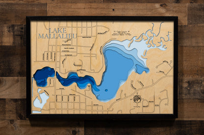 A precision laser-cut, multi-layered wooden map of Lake Mallalieu in St. Croix County, Wisconsin, a 289-acre Willow River flowage in North Hudson connected to the St. Croix River near the Minnesota border. The natural wood top layer captures 5 miles of natural shoreline in fine detail, while a light-to-dark blue gradient conveys the lake's shallow, river-connected character. A handcrafted statement piece for any Wisconsin lake home, Hudson-area cabin, or outdoor enthusiast's wall.