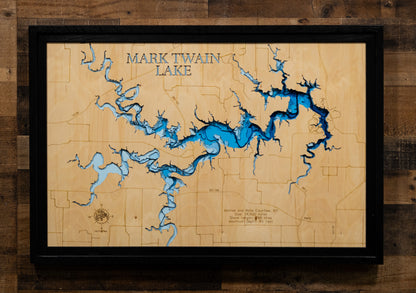 A precision laser-cut, multi-layered wooden map of Mark Twain Lake in Ralls and Monroe Counties, Missouri, an 18,600-acre Salt River reservoir completed in 1984 with 285 miles of undeveloped shoreline near the birthplace of Mark Twain. The natural wood top layer captures every cove and creek arm in fine detail, while a light-to-dark blue gradient conveys the lake's 85-foot depth. A handcrafted statement piece for any Missouri lake home, cabin, or outdoor enthusiast's wall.