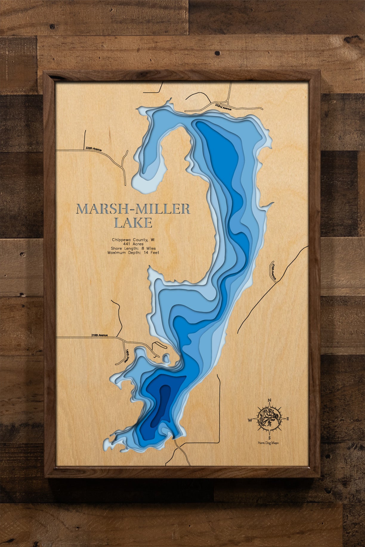 A meticulously detailed, laser-cut, multi-layered wooden topographical map of Marsh-Miller Lake (Mill Pond) in Chippewa County, Wisconsin, showcasing the 441-acre millpond flowage with the old river channel running north to south and depth contours from the 7-foot average to the 14-foot maximum. The natural wood top layer frames approximately eight miles of shoreline including Marsh Miller Cedars State Natural Area, two resort locations, weeds and timber structure, while graduated blue layers create a gentl