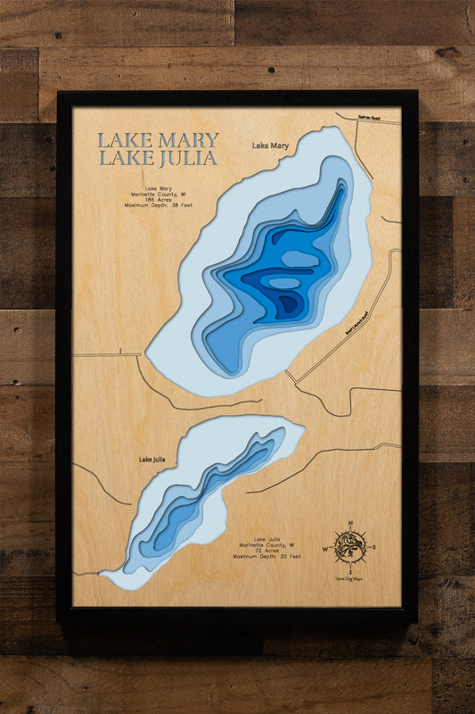 A precision laser-cut, multi-layered wooden map of Lake Mary in Marinette County, Wisconsin. The natural wood top layer captures the lake's clean, organic shoreline in fine detail, while a light-to-dark blue gradient highlights the water's depth and dimension. A distinctive, rustic statement piece crafted for cabin walls, fishing lodges, or any Wisconsin Northwoods-inspired living space.