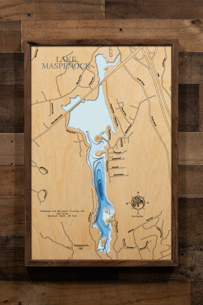 A meticulously detailed, laser-cut wooden topographic map of Lake Maspenock spanning Hopkinton in Middlesex County and Upton and Milford in Worcester Counties, Massachusetts. The multi-layered artwork showcases the lake's 234-acre surface, depth contours revealing the 26-foot maximum depth, the distinctive two-mile north-south orientation, and Sandy Island connected to shore.
