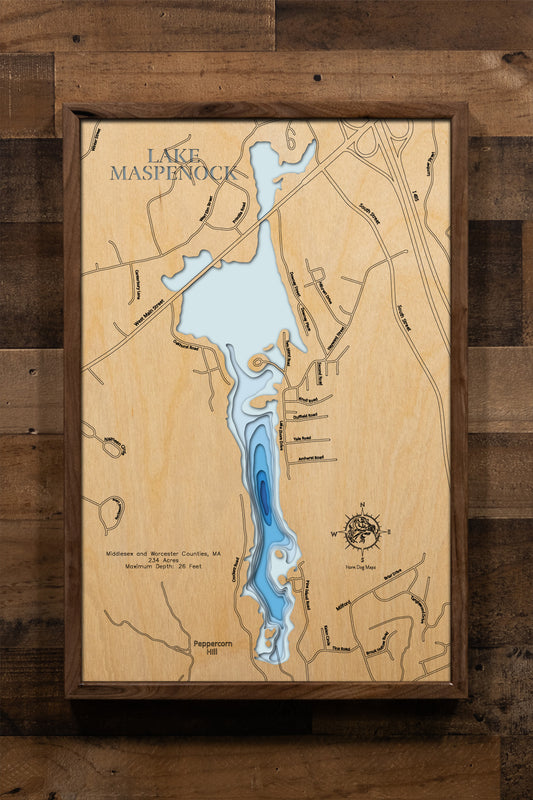 A meticulously detailed, laser-cut wooden topographic map of Lake Maspenock spanning Hopkinton in Middlesex County and Upton and Milford in Worcester Counties, Massachusetts. The multi-layered artwork showcases the lake's 234-acre surface, depth contours revealing the 26-foot maximum depth, the distinctive two-mile north-south orientation, and Sandy Island connected to shore.