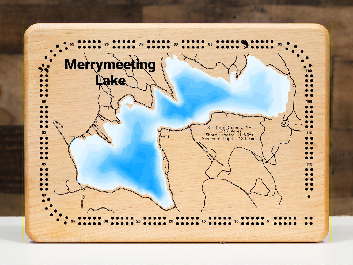 A magnificently detailed, laser-cut, multi-layered wooden topographical map of Merrymeeting Lake in Strafford County, New Hampshire, showcasing the 1,233-acre spring-fed lake's distinctive irregular hourglass shape with dramatic depth contours from the 29-foot average to the impressive 120-foot maximum depth. The natural wood top layer frames 11 miles of intricate shoreline including the dam, Merrymeeting River outlet to Lake Winnipesaukee, and protected conservation lands, while graduated blue layers creat