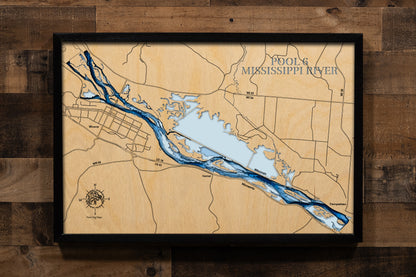 A highly detailed, laser-cut, and multi-layered wooden map of Mississippi River Pool 6, an impoundment on the Upper Mississippi River, spanning Wisconsin and Minnesota. The map illustrates the vast 22,000-acre complex of backwaters, islands, and the deep, navigable main channel. The location of Lock and Dam 6 near Trempealeau, WI, is highlighted on the lower section of the map.