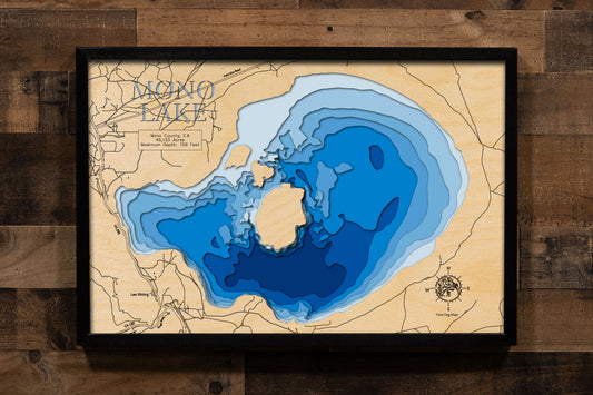 A laser-cut, layered wood map of Mono Lake, California, highlighting its shoreline and iconic tufa formations.