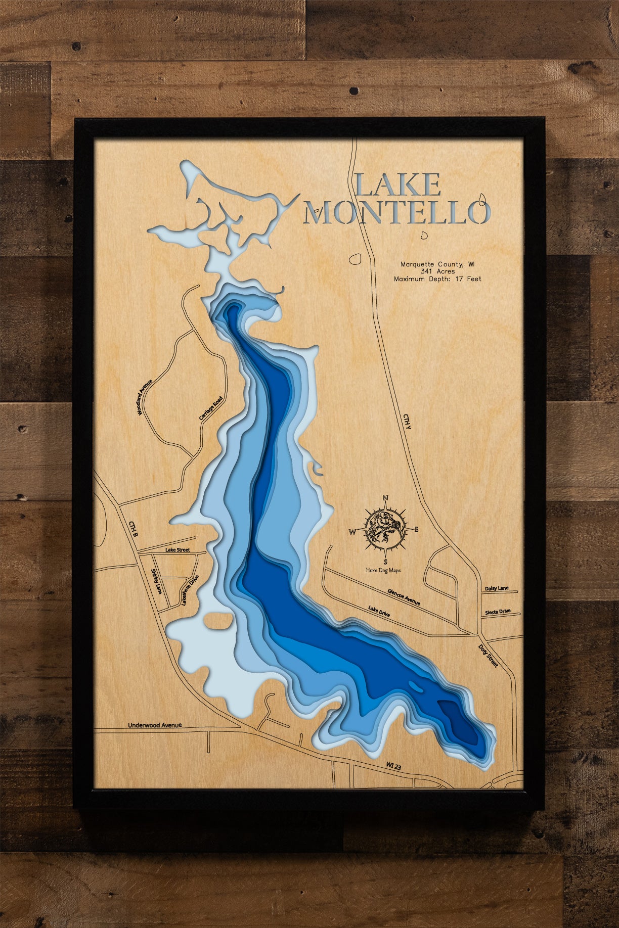 A precision laser-cut, multi-layered wooden map of Lake Montello in Marquette County, Wisconsin. The natural wood top layer traces the shoreline of this Fox River chain lake in fine detail, while a light-to-dark blue gradient conveys the lake's shallow, warmwater character. A handcrafted statement piece for any central Wisconsin lake home, cabin, or outdoor enthusiast's wall.
