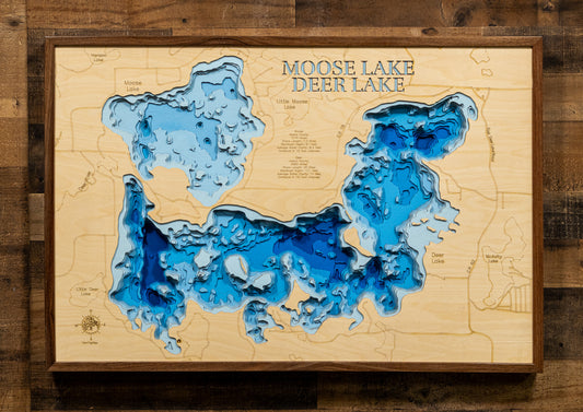 Laser-engraved relief map of Moose Lake and Deer Lake in Itasca County, MN, crafted from wood with high precision.