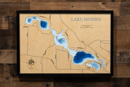 A precision laser-cut, multi-layered wooden map of Lake Morris in Waushara County, Wisconsin. The natural wood top layer renders the shoreline of this Central Sands lake in fine detail, while a light-to-dark blue gradient highlights its 40-foot depth and sandy lakebed. A handcrafted statement piece for any Wisconsin lake cabin, great room, or outdoor enthusiast's wall.