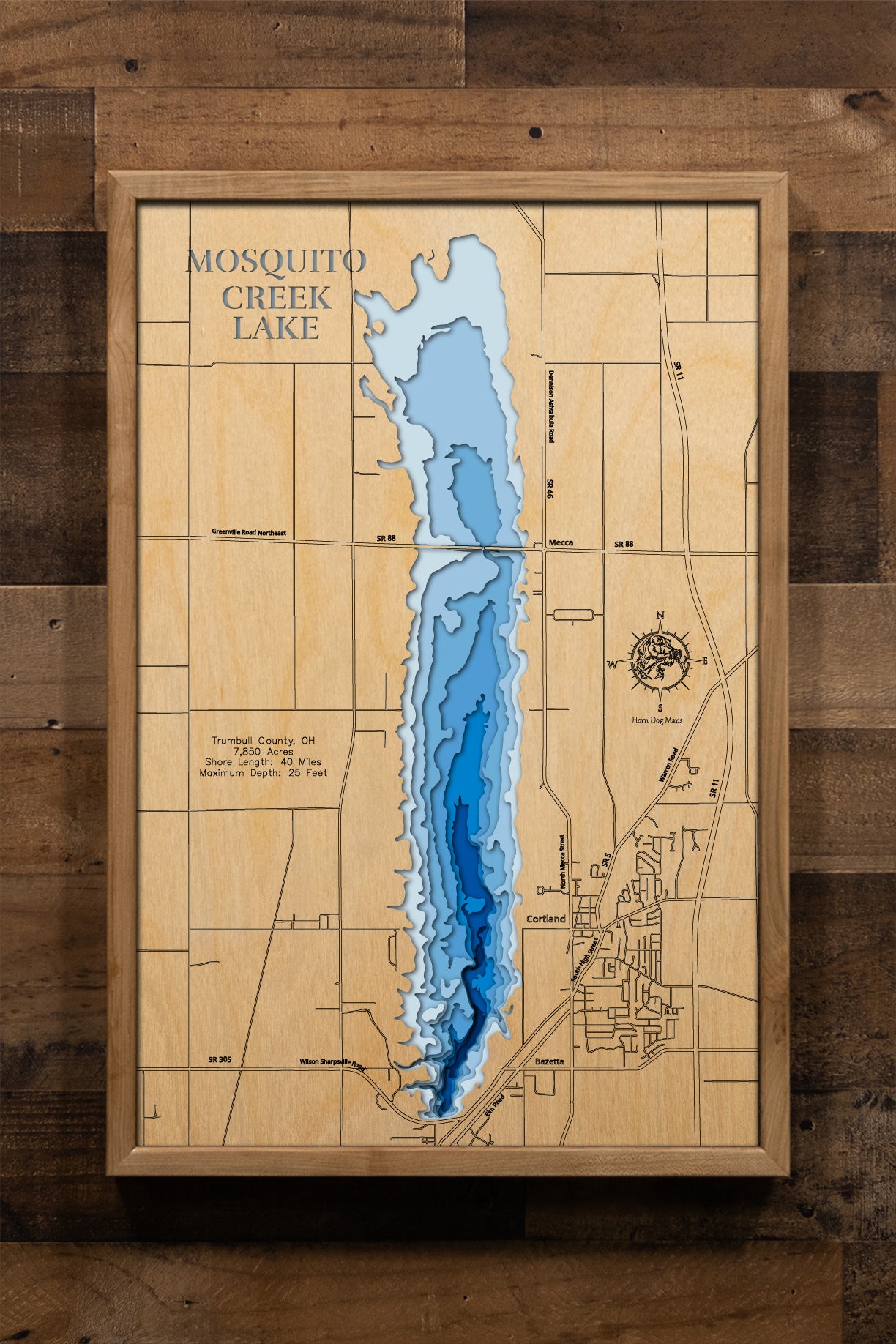 A highly detailed, laser-cut, and multi-layered wooden map of Mosquito Creek Lake in Trumbull County, Ohio. The map showcases the reservoir's expansive 7,850-acre surface bisected by the State Route 88 causeway, depth contours illustrating the varying depths from shallow northern waters to the 25-foot maximum at the dam, and the intricate 40 miles of shoreline.