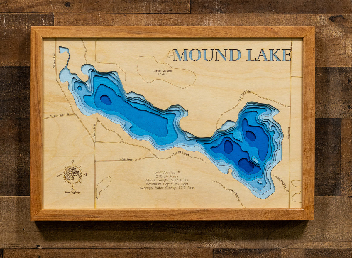 A framed wooden depth map of Mound Lake, featuring layered blue wood sections representing water depth, mounted on a rustic dark wood wall.
