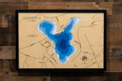 A precision laser-cut, multi-layered wooden map of Nuangola Lake in Luzerne County, Pennsylvania — a 102-acre heart-shaped lake nestled in a historic resort borough in the Wyoming Valley highlands. The natural wood top layer captures the lake's distinctive triangular shoreline in fine detail, while a light-to-dark blue gradient conveys its 29-foot depth. A handcrafted statement piece for any Pennsylvania lake home, Pocono-area cabin, or outdoor enthusiast's wall.