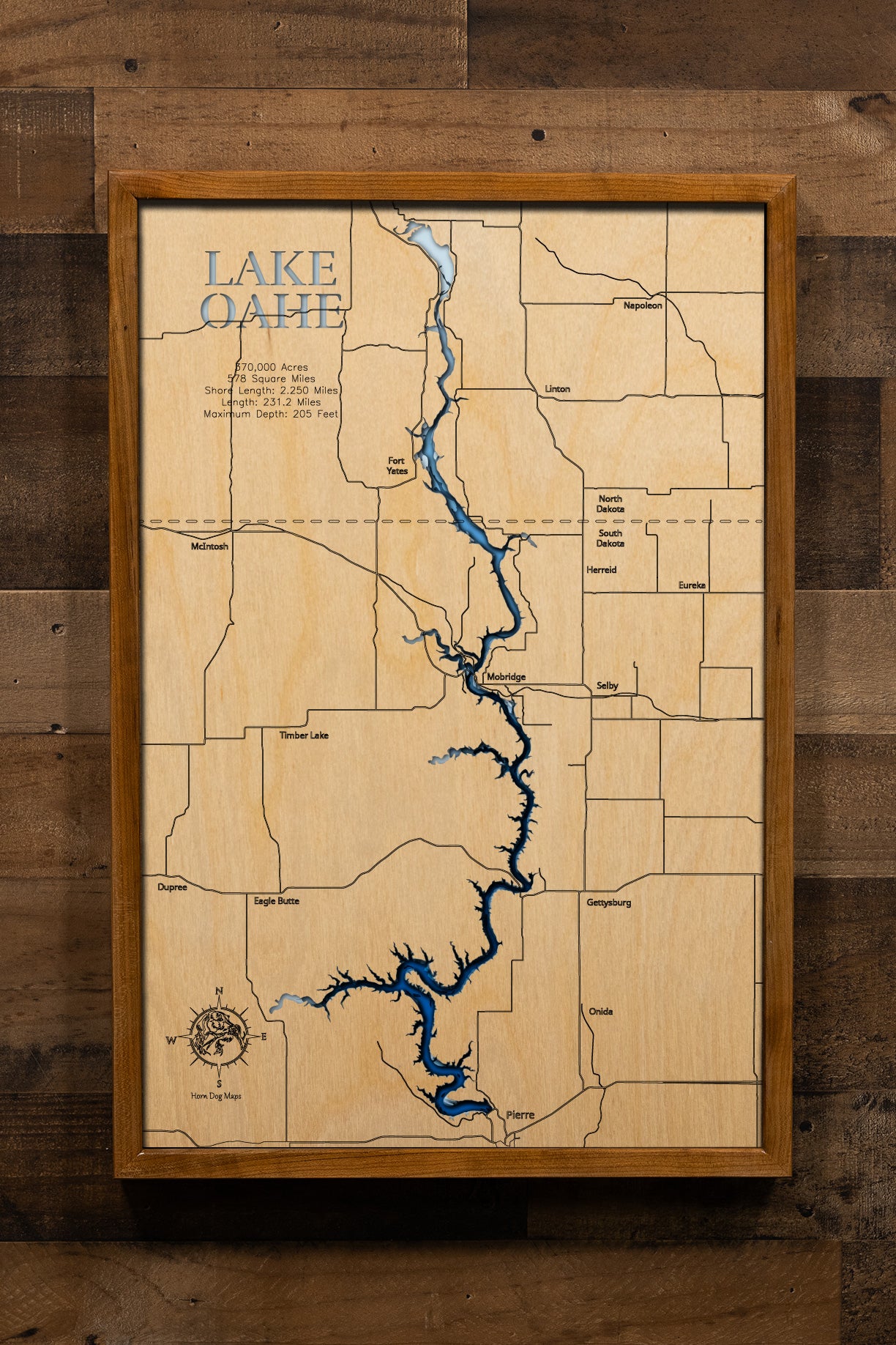 A highly detailed, laser-cut, and multi-layered wooden map of Lake Oahe spanning South Dakota and North Dakota. The map illustrates the reservoir's impressive 231-mile length along the Missouri River, with depth contours showing the 205-foot maximum depth, and the intricate 2,250 miles of meandering shoreline across 14 counties.
