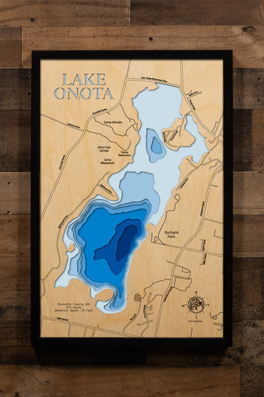 A precision laser-cut, multi-layered wooden map of Lake Onota in Berkshire County, Massachusetts — a 617-acre great pond in Pittsfield with two distinct basins and a maximum depth of 72 feet. The natural wood top layer captures the lake's varied shoreline in fine detail, while a light-to-dark blue gradient conveys its striking depth. A handcrafted statement piece for any Berkshires home, New England cabin, or outdoor enthusiast's wall.
