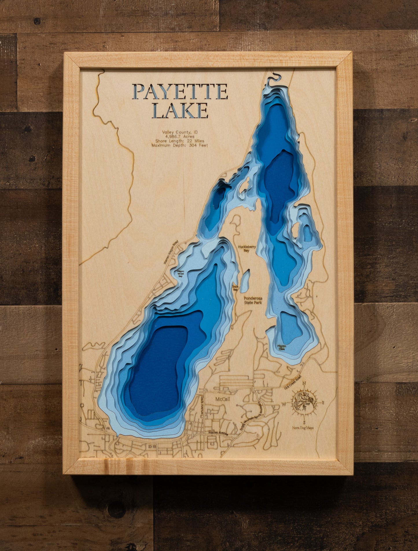 A laser-cut, layered wood map of Payette Lake, Valley County, Idaho, highlighting its deep blue waters and mountainous perimeter.