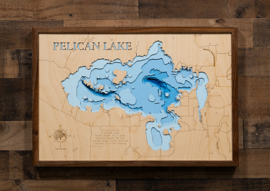 A laser-cut, layered wooden map of Pelican Lake in St. Louis County, Minnesota. The distinct shape of this large lake, with its 55.71-mile shoreline and numerous islands, is clearly visible within the forested landscape of northern Minnesota near the town of Orr. The varying depths of the lake, reaching a maximum of 40 feet, are represented by different layers of wood, illustrating its impressive underwater topography.