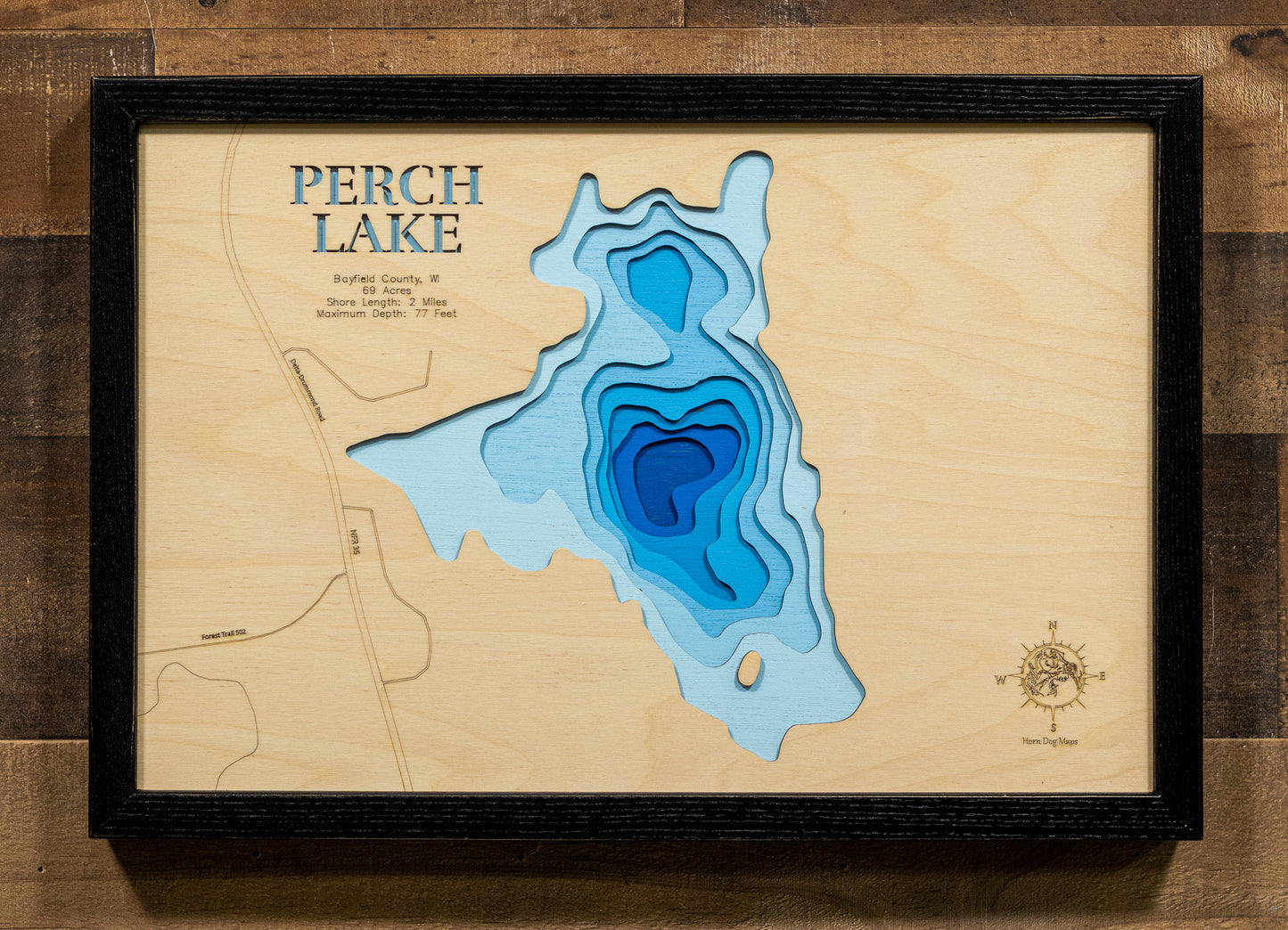 A meticulously detailed, laser-cut, multi-layered wooden topographical map of Perch Lake in Bayfield County, Wisconsin, showcasing the 69-acre lake depth. 