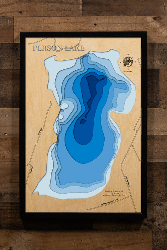 A laser-cut, multi-layered wooden map of Person Lake in Douglas County, Wisconsin, featuring a natural wood top layer and a light-to-dark blue gradient representing the lake's depth. Crafted with precision, each contour layer adds texture and dimension, making it an eye-catching, rustic decor piece ideal for a cabin, den, or Northwoods-themed living space.