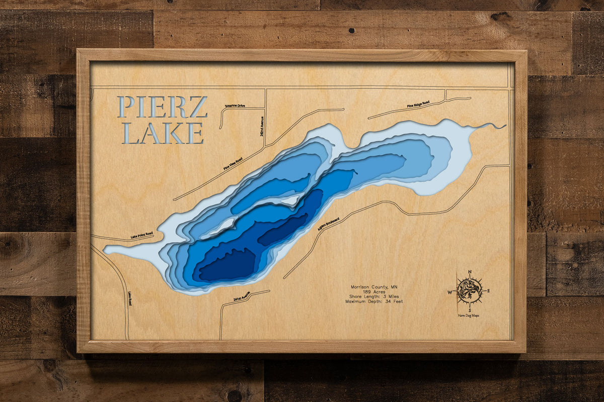 A precision laser-cut, multi-layered wooden map of Pierz Lake in Morrison County, Minnesota, a 189-acre lake near the city of Pierz named for a 19th-century Catholic missionary to the Ojibwe. The natural wood top layer captures 3 miles of shoreline in fine detail, while a light-to-dark blue gradient conveys the lake's 34-foot depth. A handcrafted statement piece for any Minnesota lake home, cabin, or outdoor enthusiast's wall.
