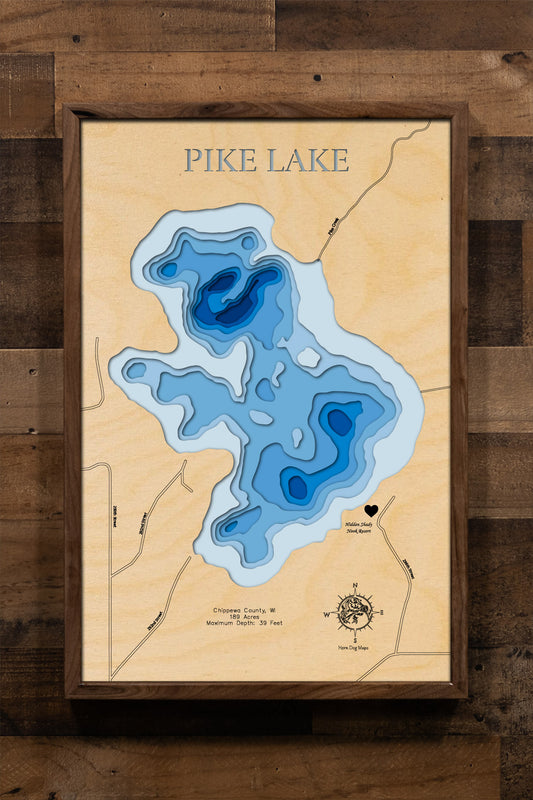A highly detailed, laser-cut, and multi-layered wooden map of Pike Lake, a natural lake in Chippewa County, Wisconsin. The map shows the lake's distinct shape and its 2.15-mile shoreline. The varying depths of the lake, reaching a maximum of 35 feet, are represented by different layers of wood.