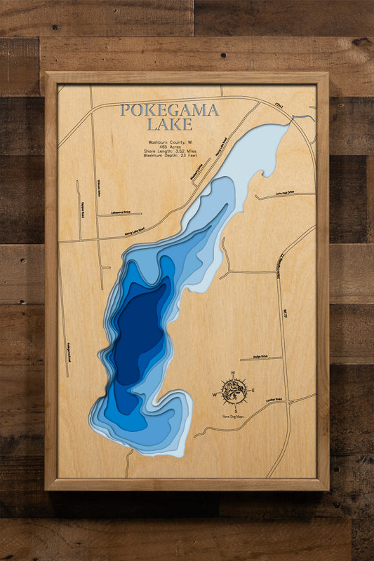 A meticulously crafted laser-cut wooden lake map of Pokegama Lake in Washburn County, Wisconsin. The map features the lake's accurate shape and detailed shoreline, with its impressive depth represented by a deep blue stain. Meticulously etched details include the lake's unique shape, its shore length, and maximum depth, providing both a beautiful piece of art and a detailed, informative guide to this popular Wisconsin lake.