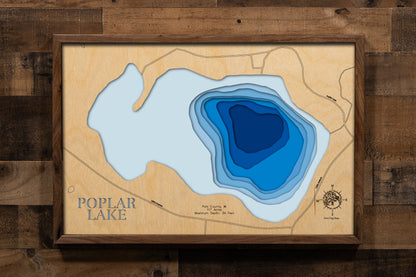 A beautifully crafted, multi-layered wooden topographic map of Poplar Lake in Polk County, Wisconsin. The laser-cut design reveals the lake's 117-acre footprint with depth contours descending to the 34-foot maximum depth, the distinct muck and sand bottom composition zones, and the peaceful shoreline setting in northwest Wisconsin's St. Croix Valley region.