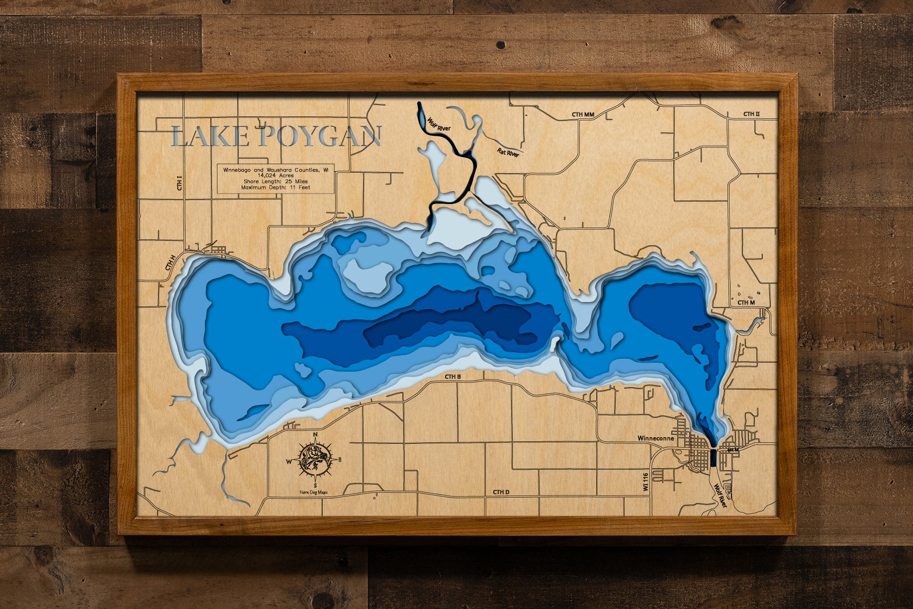 A precision laser-cut, multi-layered wooden map of Lake Poygan spanning Winnebago and Waushara Counties, Wisconsin. The natural wood top layer captures 25 miles of shoreline and the lake's sweeping, shallow basin in fine detail, while a light-to-dark blue gradient highlights the water's depth and dimension. A stunning, rustic statement piece for any Wisconsin lake home, fishing lodge, or sports room.