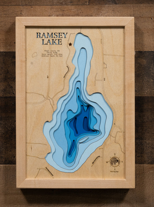 A custom-engraved, laser-cut wooden lake map of Ramsey Lake in Wright County, Minnesota. The map features the lake’s accurate shape and detailed shoreline, with its impressive maximum depth of 80 feet represented by a deep blue stain. The design includes elegantly etched details of the lake's unique shape and surrounding features, providing both a beautiful piece of art and a detailed, informative guide to this popular Minnesota lake.