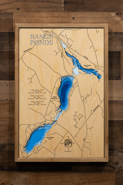 A highly detailed, laser-cut, and multi-layered wooden map of Upper, Middle, and Lower Range Ponds, an interconnected three-lake chain in Poland, Maine. The map shows the distinct shapes of the ponds and their extensive combined shoreline, highlighting the location of Range Ponds State Park on Lower Range Pond. The varying depths of the ponds, reaching a maximum of 66 feet in Middle Range Pond, are represented by different layers of wood.