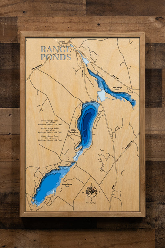 A highly detailed, laser-cut, and multi-layered wooden map of Upper, Middle, and Lower Range Ponds, an interconnected three-lake chain in Poland, Maine. The map shows the distinct shapes of the ponds and their extensive combined shoreline, highlighting the location of Range Ponds State Park on Lower Range Pond. The varying depths of the ponds, reaching a maximum of 66 feet in Middle Range Pond, are represented by different layers of wood.