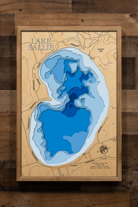 A precision laser-cut, multi-layered wooden map of Lake Sallie in Becker County, Minnesota, a 1,280-acre lake near Detroit Lakes holding one of the most diverse fisheries in west-central Minnesota. The natural wood top layer captures 6 miles of shoreline in fine detail, while a light-to-dark blue gradient conveys the lake's 50-foot depth. A handcrafted statement piece for any Minnesota lake home, cabin, or outdoor enthusiast's wall.