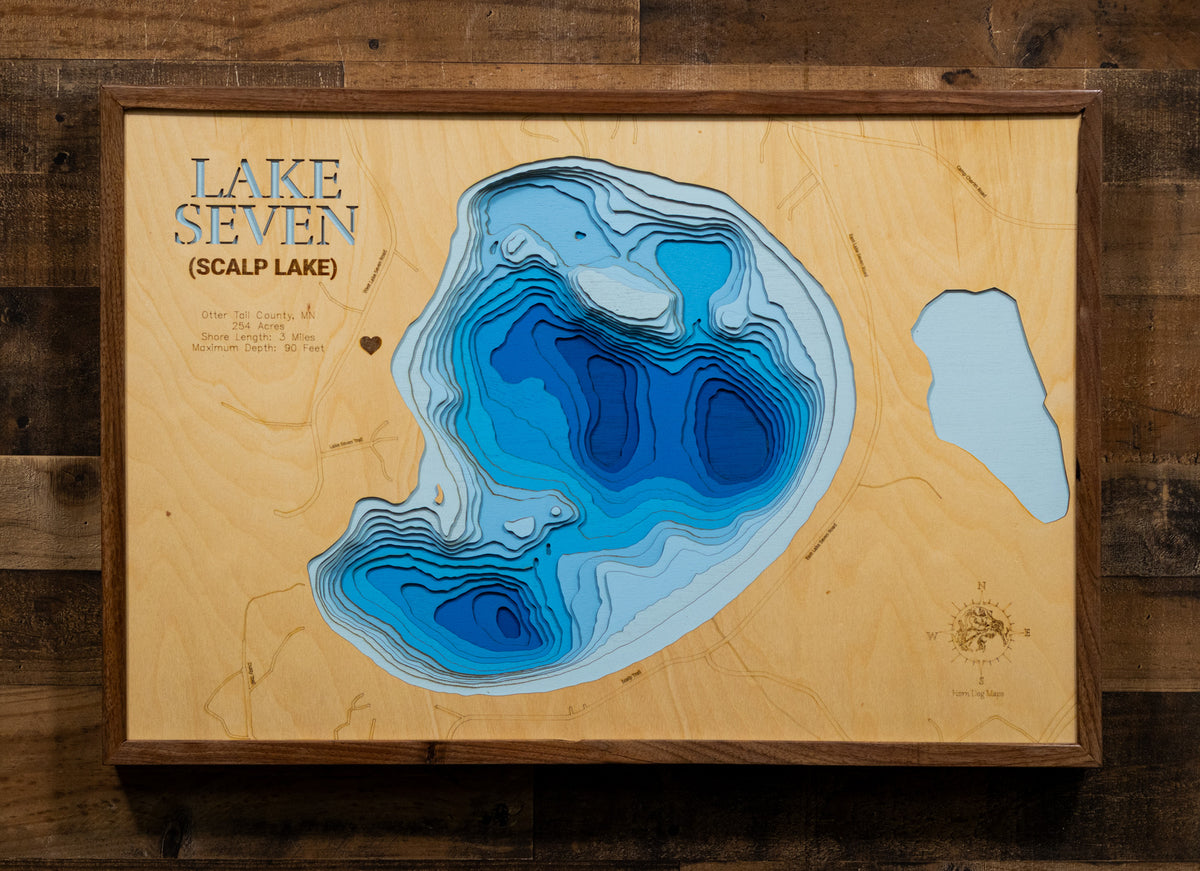 A meticulously detailed, laser-cut, multi-layered wooden topographical map of Scalp Lake in Otter Tail County, Minnesota, showcasing the 254-acre lake's surface with dramatic depth contours illustrating the transition from shallower areas to the impressive 90-foot maximum depth. The natural wood top layer frames three miles of shoreline with the public boat launch, while graduated blue layers create a striking visual depth gradient.