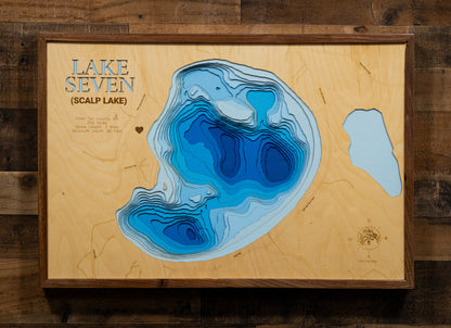 A meticulously detailed, laser-cut, multi-layered wooden topographical map of Scalp Lake in Otter Tail County, Minnesota, showcasing the 254-acre lake's surface with dramatic depth contours illustrating the transition from shallower areas to the impressive 90-foot maximum depth. The natural wood top layer frames three miles of shoreline with the public boat launch, while graduated blue layers create a striking visual depth gradient.