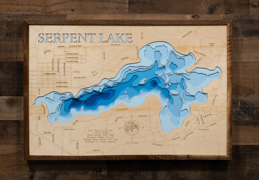 A laser-cut, layered wooden map of Serpent Lake in Crow Wing County, Minnesota. The distinct shape of this natural lake, with its 8.93-mile shoreline, is clearly visible within the forested landscape of central Minnesota near the towns of Crosby and Deerwood. The varying depths of the lake, reaching a maximum of 65 feet, are represented by different layers of wood, illustrating its impressive underwater topography.