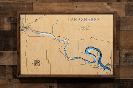 A stunning multi-layered, laser-cut wooden topographic map of Lake Sharpe stretching through Buffalo, Lyman, Hyde, Hughes, and Stanley Counties in central South Dakota. The intricate design captures the reservoir's serpentine 80-mile course from Big Bend Dam to Oahe Dam, depth contours showing the 78-foot maximum depth, the dramatic Big Bend horseshoe meander, and 200 miles of shoreline along the mighty Missouri River.