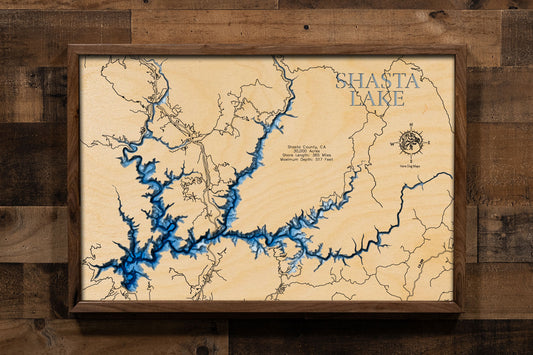 A laser-cut, layered wood map of Lake Shasta, California, showcasing its intricate shoreline and surrounding mountain terrain.