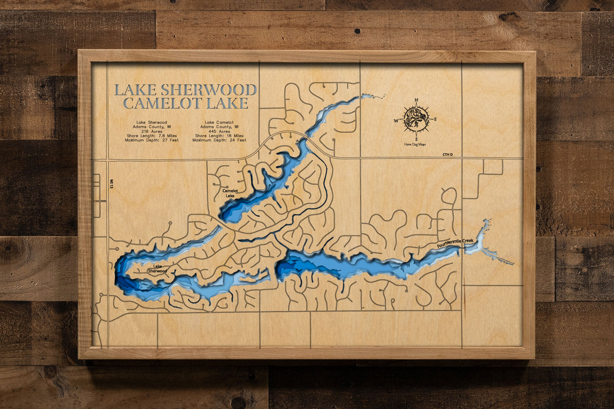 A precision laser-cut, multi-layered wooden map of Lake Camelot and Lake Sherwood in Adams County, Wisconsin, a connected pair of all-sports lakes covering 661 combined acres in the Town of Rome along Fourteen Mile Creek. The natural wood top layer captures both shorelines and their connecting dam in fine detail, while a light-to-dark blue gradient conveys their sandy, shallow character. A handcrafted statement piece for any Wisconsin lake home, cabin, or outdoor enthusiast's wall.