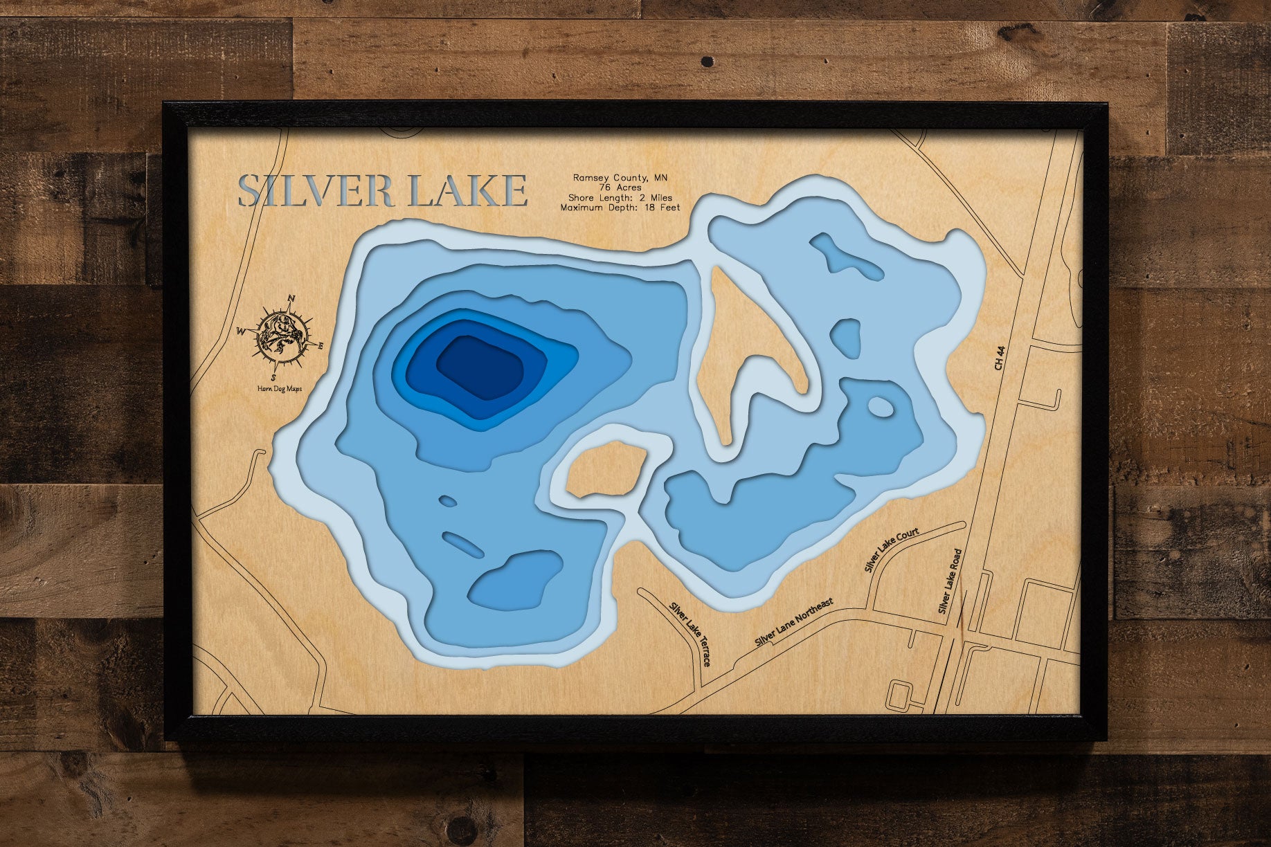 A precision laser-cut, multi-layered wooden map of Silver Lake in Ramsey County, Minnesota, a 76-acre urban lake shared by New Brighton, Maplewood, and North St. Paul in the northeastern Twin Cities metro. The natural wood top layer captures 2 miles of shoreline in fine detail, while a light-to-dark blue gradient conveys the lake's 18-foot depth. A handcrafted statement piece for any Minnesota lake home, Twin Cities cabin, or outdoor enthusiast's wall.