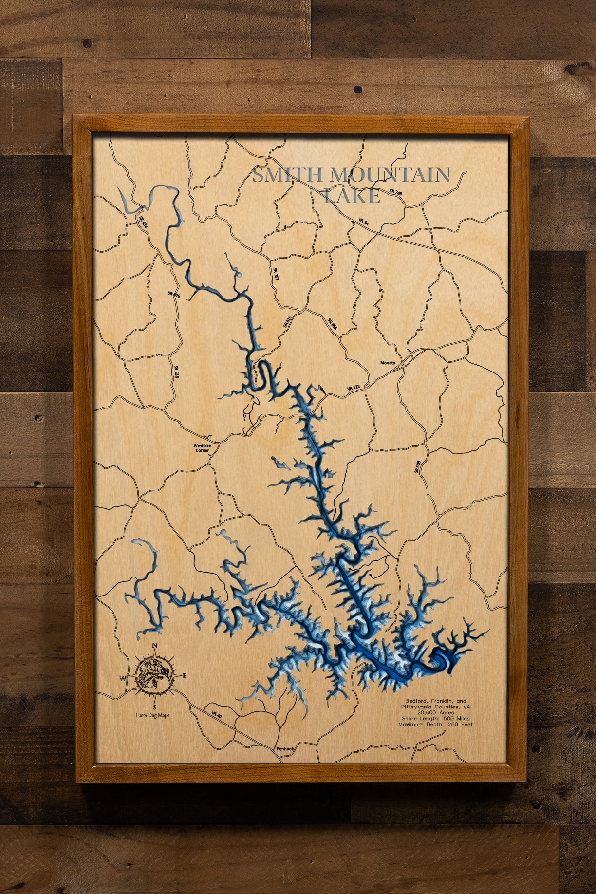 A breathtakingly detailed, laser-cut, multi-layered wooden map of Smith Mountain Lake spanning Bedford, Franklin, and Pittsylvania Counties, Virginia, showcasing the 20,600-acre reservoir's distinctive 40-mile serpentine course with 500 miles of intricate shoreline. Natural wood layers highlight the Hales Ford Bridge and surrounding Blue Ridge landscape, while graduated blue water layers illustrate depths to 250 feet.