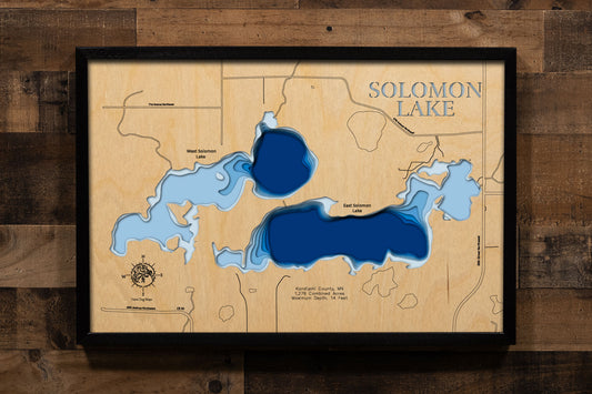 A precision laser-cut, multi-layered wooden map of East and West Solomon Lakes in Kandiyohi County, Minnesota — a connected pair of shallow prairie lakes covering 1,276 combined acres just northwest of Willmar. The natural wood top layer captures both lakes' shorelines and connecting channel in fine detail, while a light-to-dark blue gradient conveys their broad, productive character. A handcrafted statement piece for any Minnesota lake home, cabin, or outdoor enthusiast's wall.