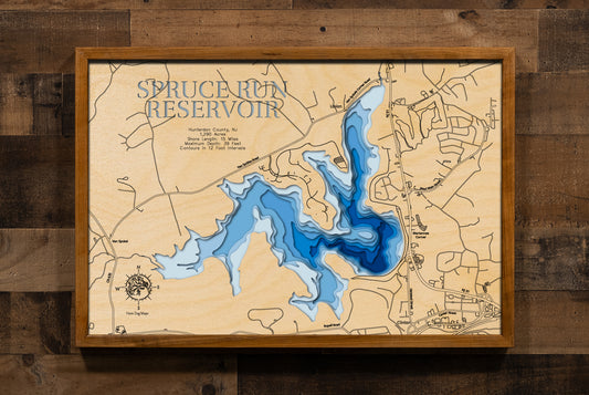 A laser-cut, layered wooden map of Spruce Run Reservoir in Hunterdon County, New Jersey. The distinct shape of this large reservoir, with its 15-mile shoreline, is clearly visible within the central New Jersey landscape. The varying depths of the lake, now confirmed to reach a maximum of 72 feet and detailed by 12-foot contour intervals, are represented by different layers of wood, illustrating its impressive underwater topography.