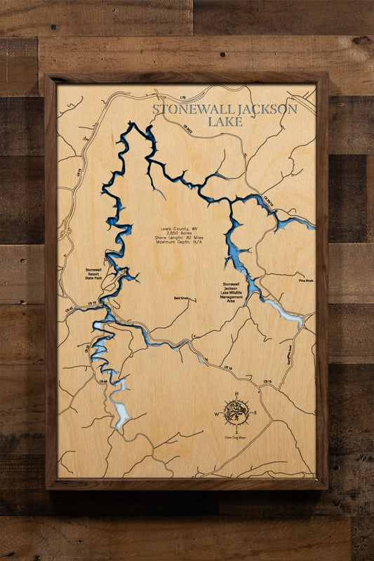 A precision laser-cut, multi-layered wooden map of Stonewall Jackson Lake in Lewis County, West Virginia. The natural wood top layer captures 82 miles of winding, wooded shoreline and the lake's dramatic V-shaped basin in fine detail, while a light-to-dark blue gradient highlights the water's depth and dimension. A distinctive, rustic statement piece for any Appalachian cabin, resort room, or West Virginia lake home.