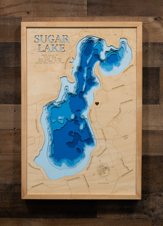 A laser-cut, layered wooden map of Sugar Lake in Wright County, Minnesota. The distinct shape of this natural lake, with its 10.63-mile shoreline, is clearly visible within the forested landscape of central Minnesota. The varying depths of the lake, reaching a maximum of 69 feet, are represented by different layers of wood, illustrating its impressive underwater topography.
